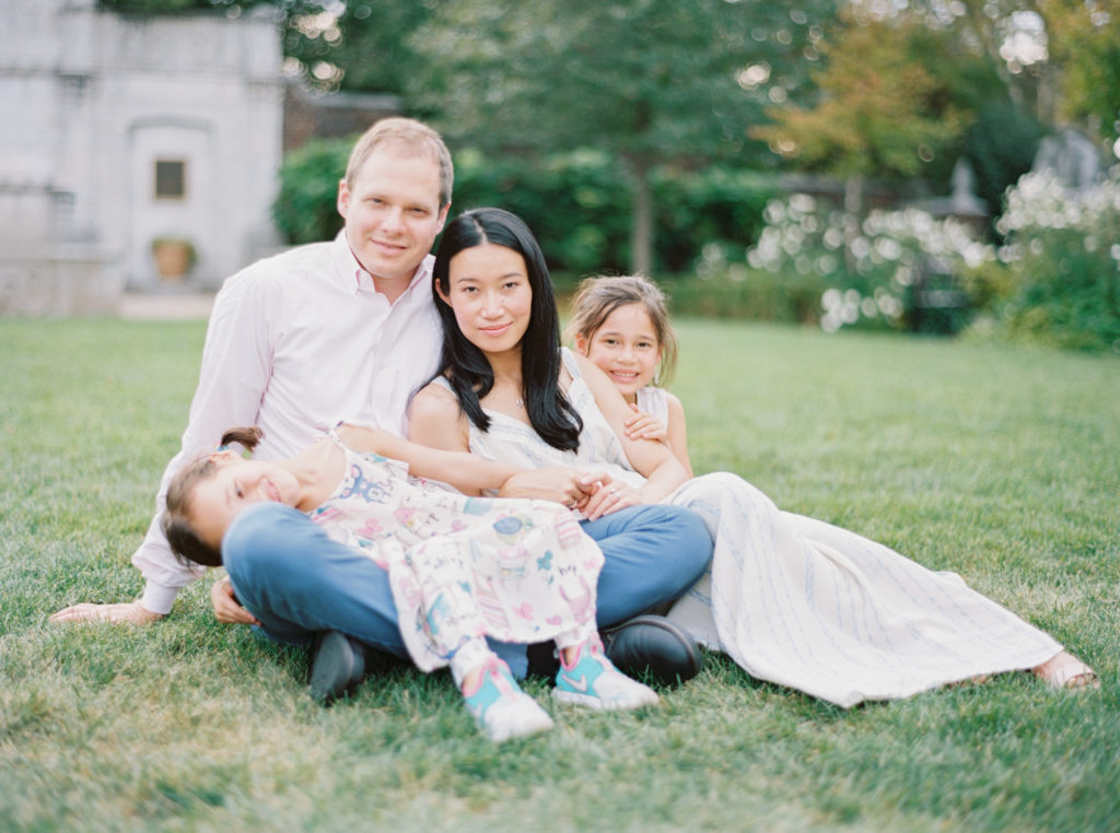 Pittsburgh florist May Chester snuggles with her family on a garden lawn at Mellon Park film photography by Pittsburgh Family Photographer Anna Laero