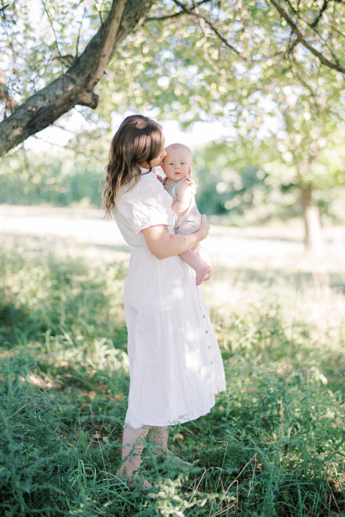 Mama in a white dress and her baby in dappled light at Old Slate Farm | Columbus Family Photographer | Anna Laero Photography